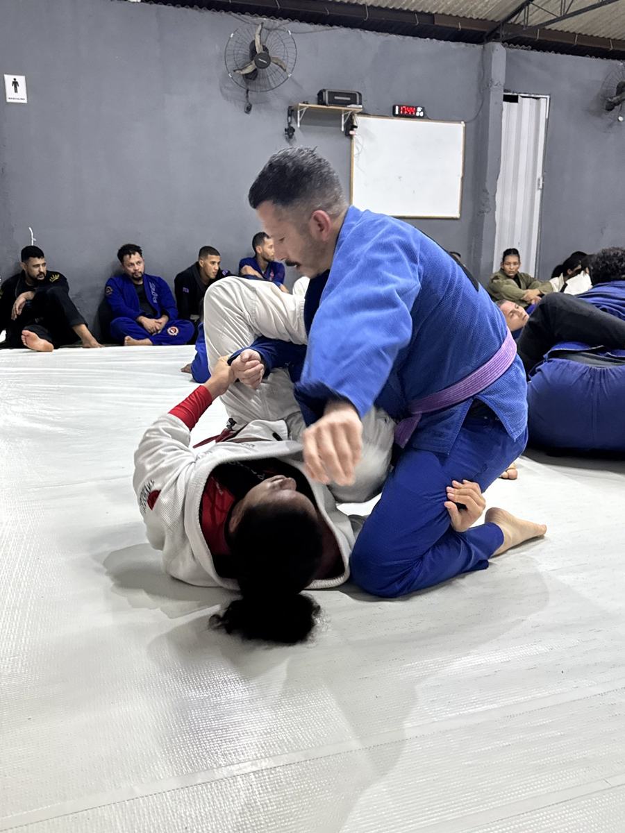 Coach rolling with a young student in Brazil
