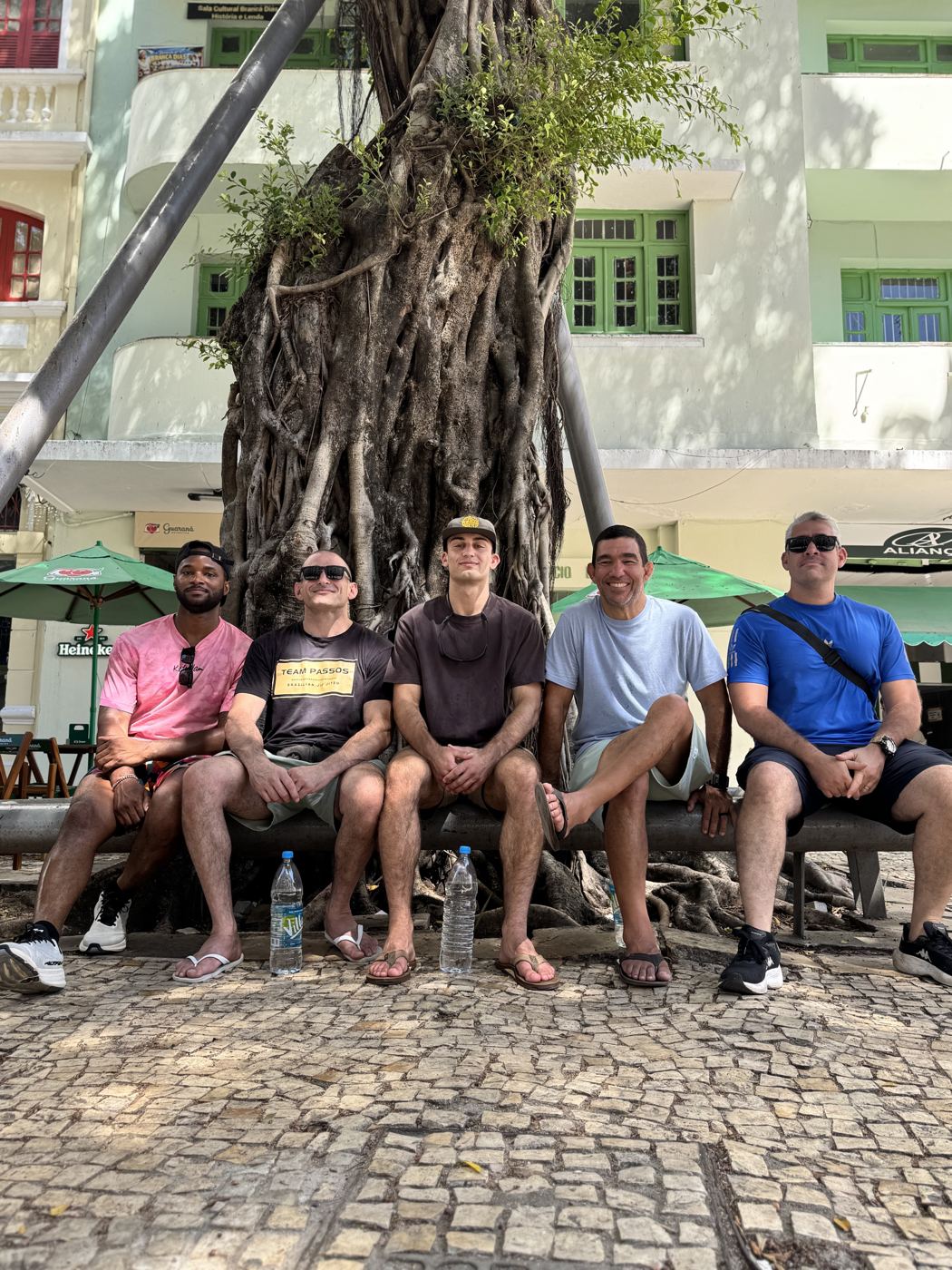 Coaches and members relaxing under a tree in Recife